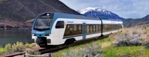 MockUp of the Stadler FLIRT headed down the tracks with the mountains in the background.