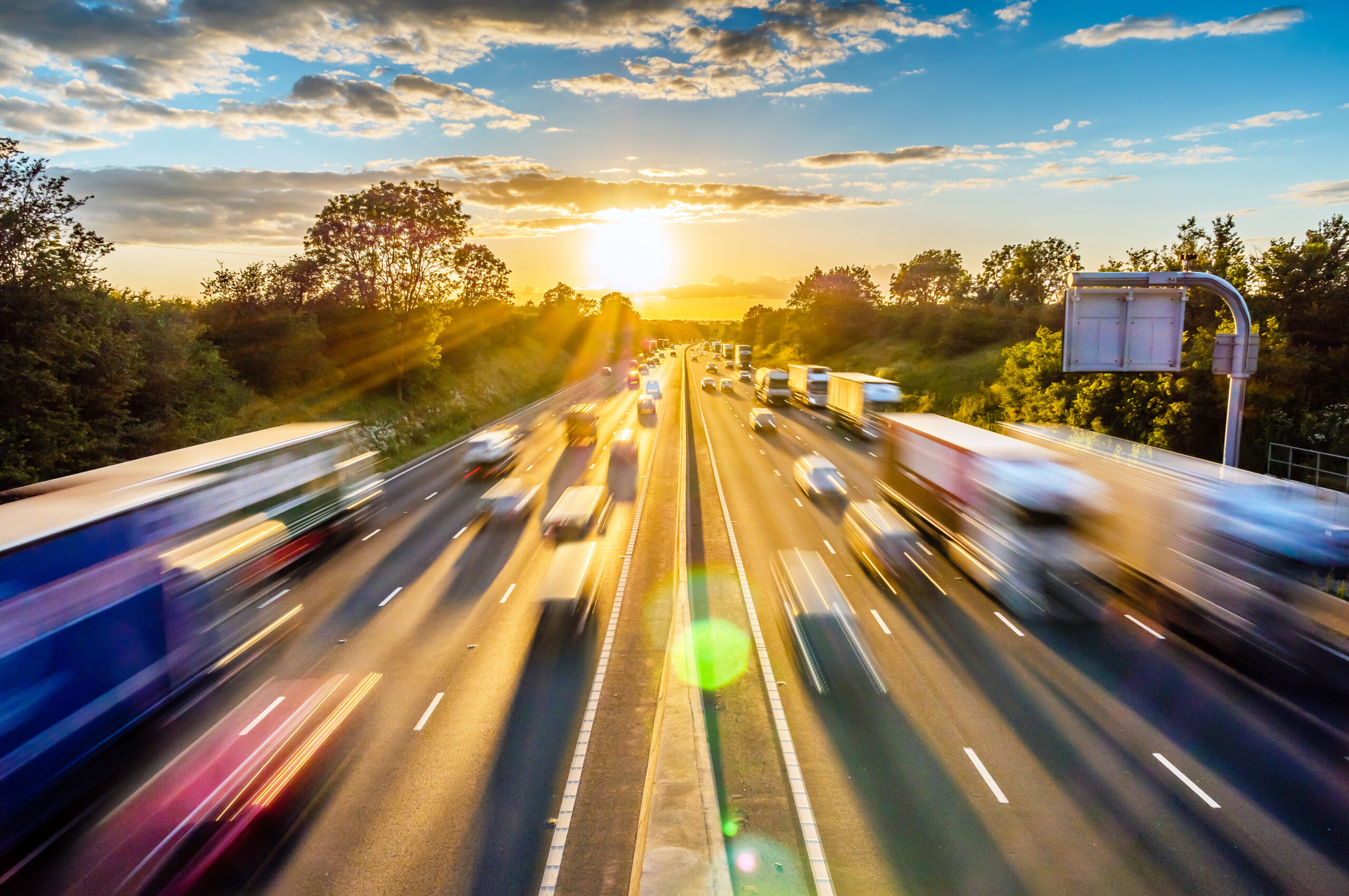 heavy traffic moving at speed on UK motorway in England at sunset heavy traffic moving at speed on UK motorway in England at sunset.
